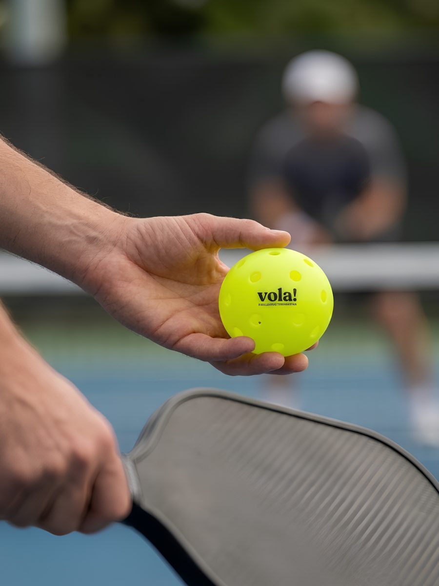 Người chơi cầm bóng pickleball vola! chuẩn bị giao bóng